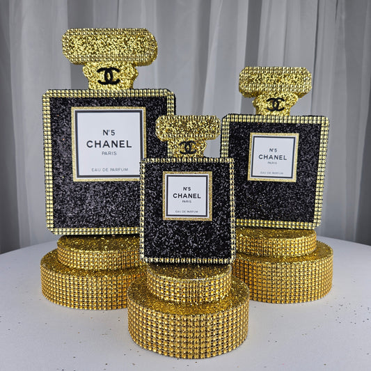 black and gold chanel birthday decorations Chanel-inspired perfume bottle centerpiece for luxury glam birthday decor