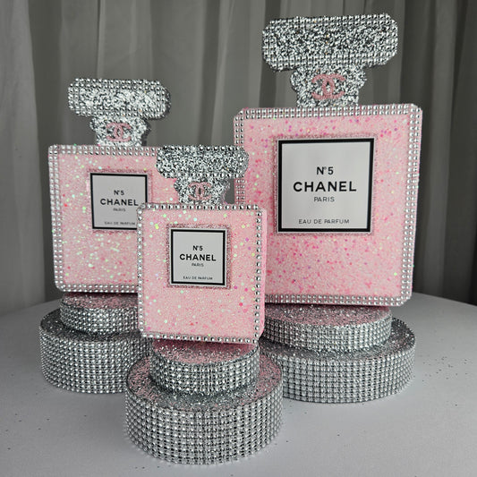 pink chanel birthday decorations Chanel inspired perfume centerpiece in pink and silver for glam Paris themed birthday party decor